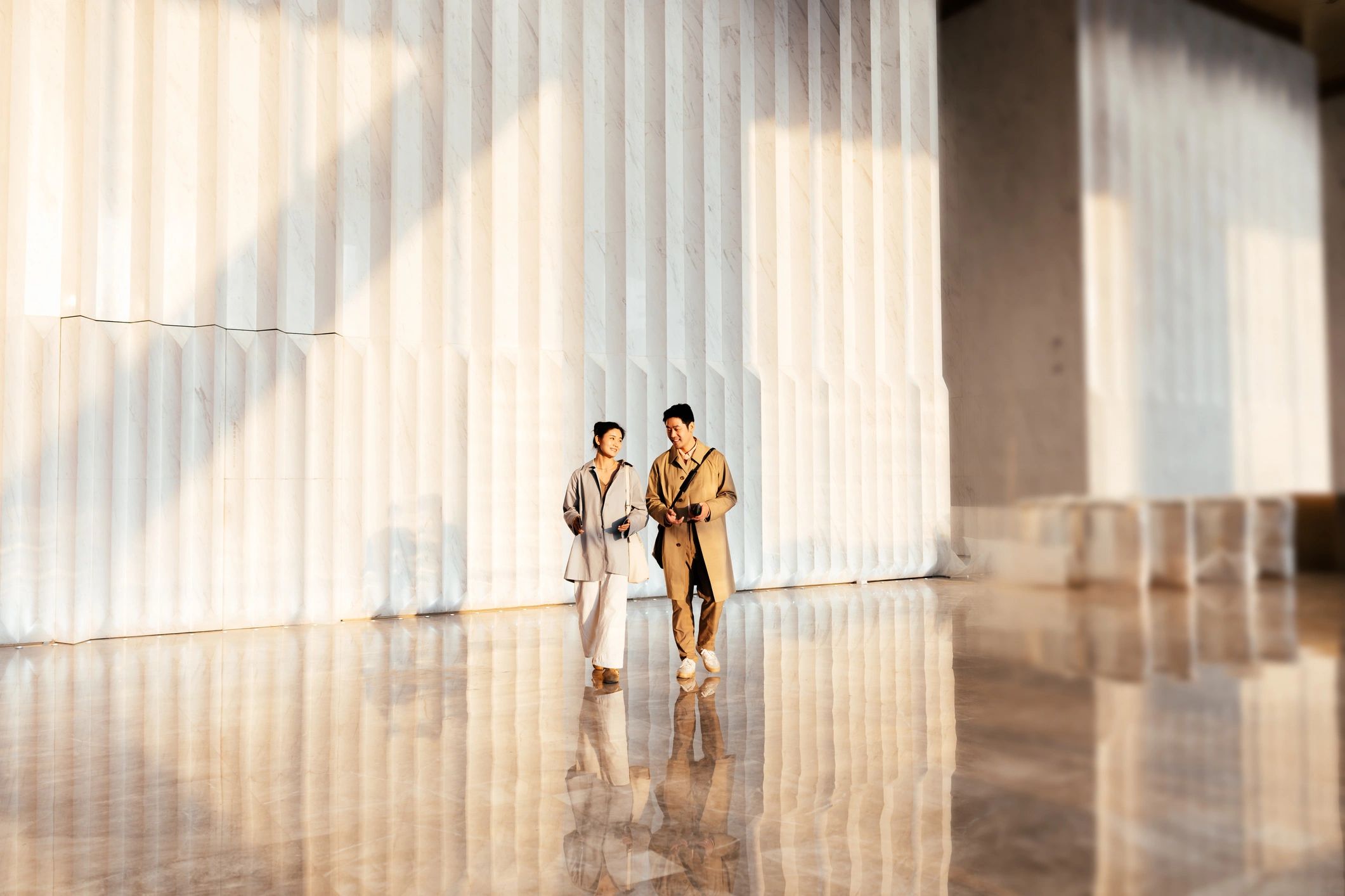 Two professionals walking together in a modern workplace